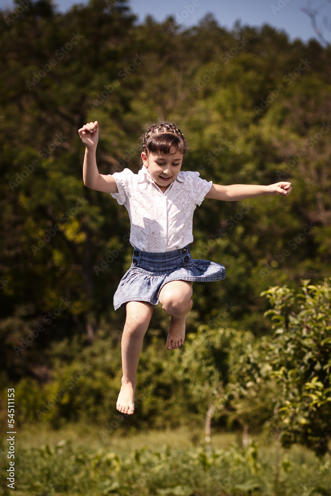 Happy summer girl teenager jumping outdoor.