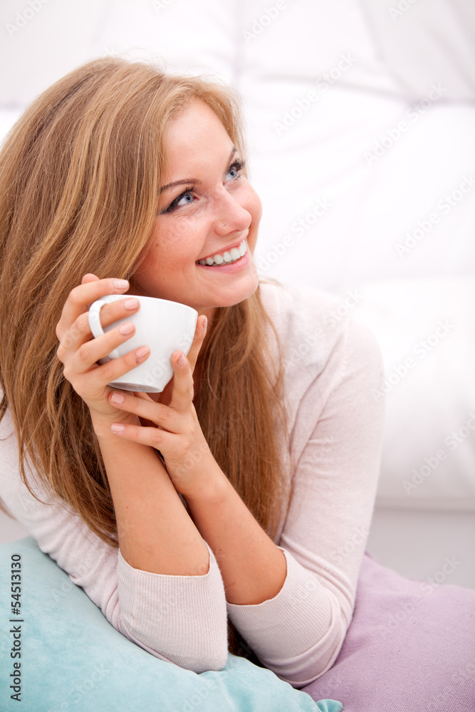 woman holding white cup