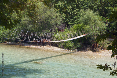 Rope bridge over Acheron river in Greece photo