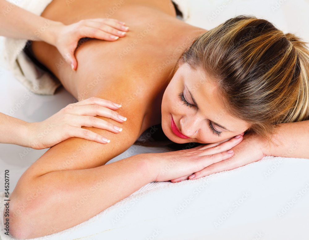 An attractive woman getting spa treatment, isolated on white An attractive woman getting spa treatment, isolated on white