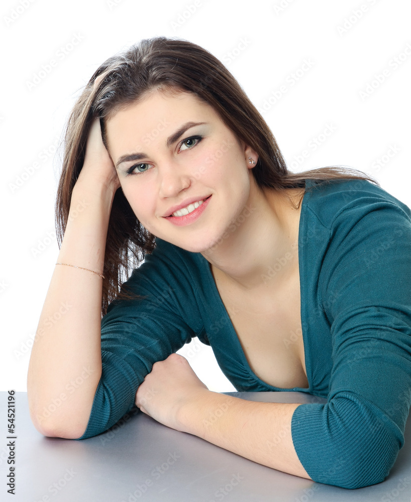 A smiling woman sitting at the desk, isolated on white
