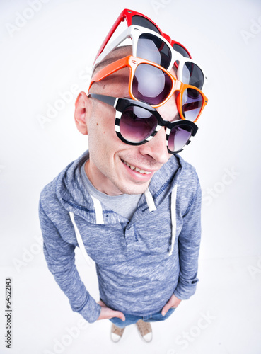 funny man with pairs of sunglasses on his head - studio shot