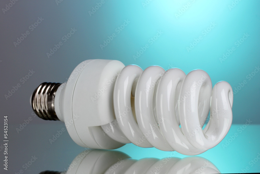 energy saving light bulb on blue background. energy saving light bulb on blue background.