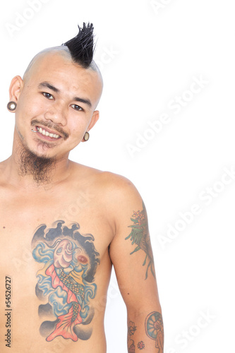 portrait of smiling asian punk guy with mohawk hair style, pierc photo