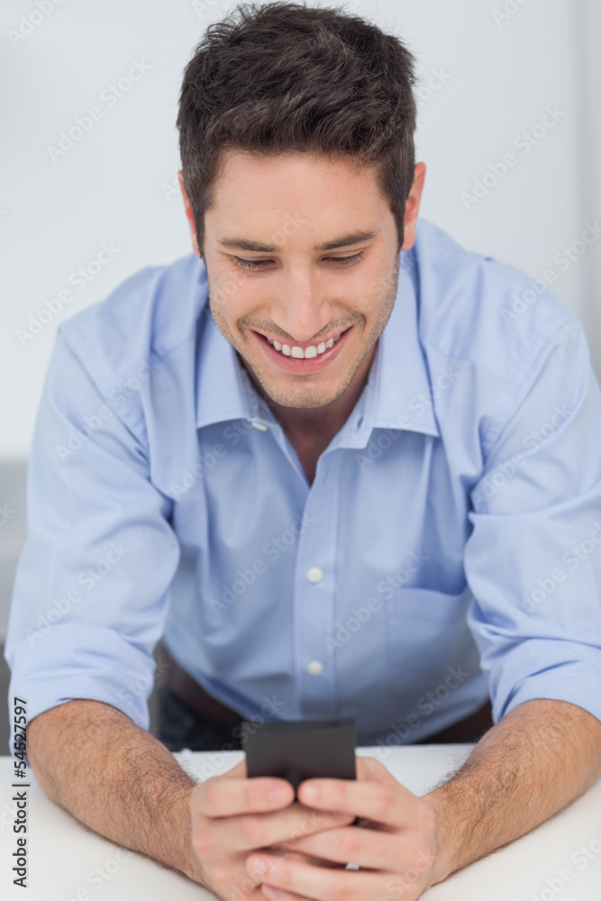 Man text messaging with his smartphone Man text messaging with his smartphone
