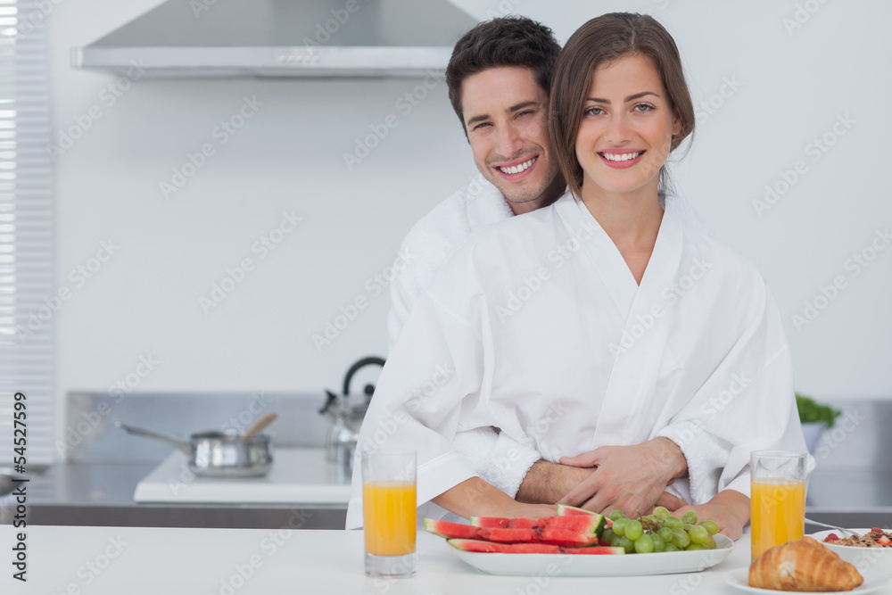 Portrait of a man embracing his wife in the kitchen Portrait of a man embracing his wife in the kitchen
