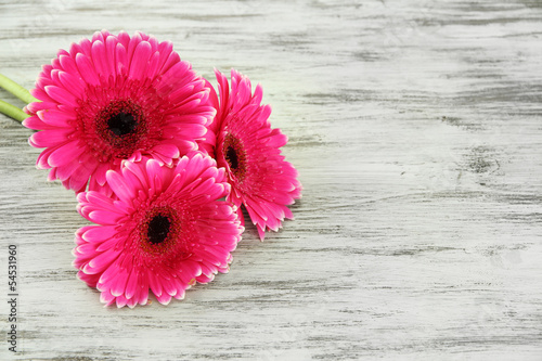Fototapeta Naklejka Na Ścianę i Meble -  Beautiful pink gerbera flowers on wooden table