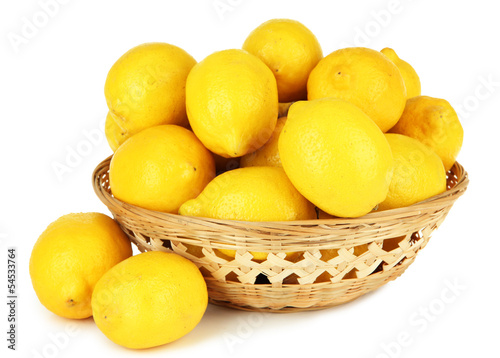 Ripe lemons in wicker basket isolated on white