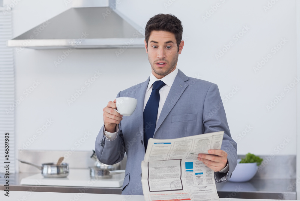 Businessman being astonished when reading the news Businessman being astonished when reading the news