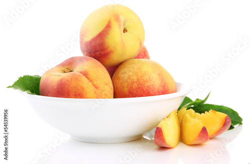 Ripe sweet peaches in bowl  isolated on white
