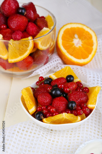 Useful fruit salad in glass cup and bowl