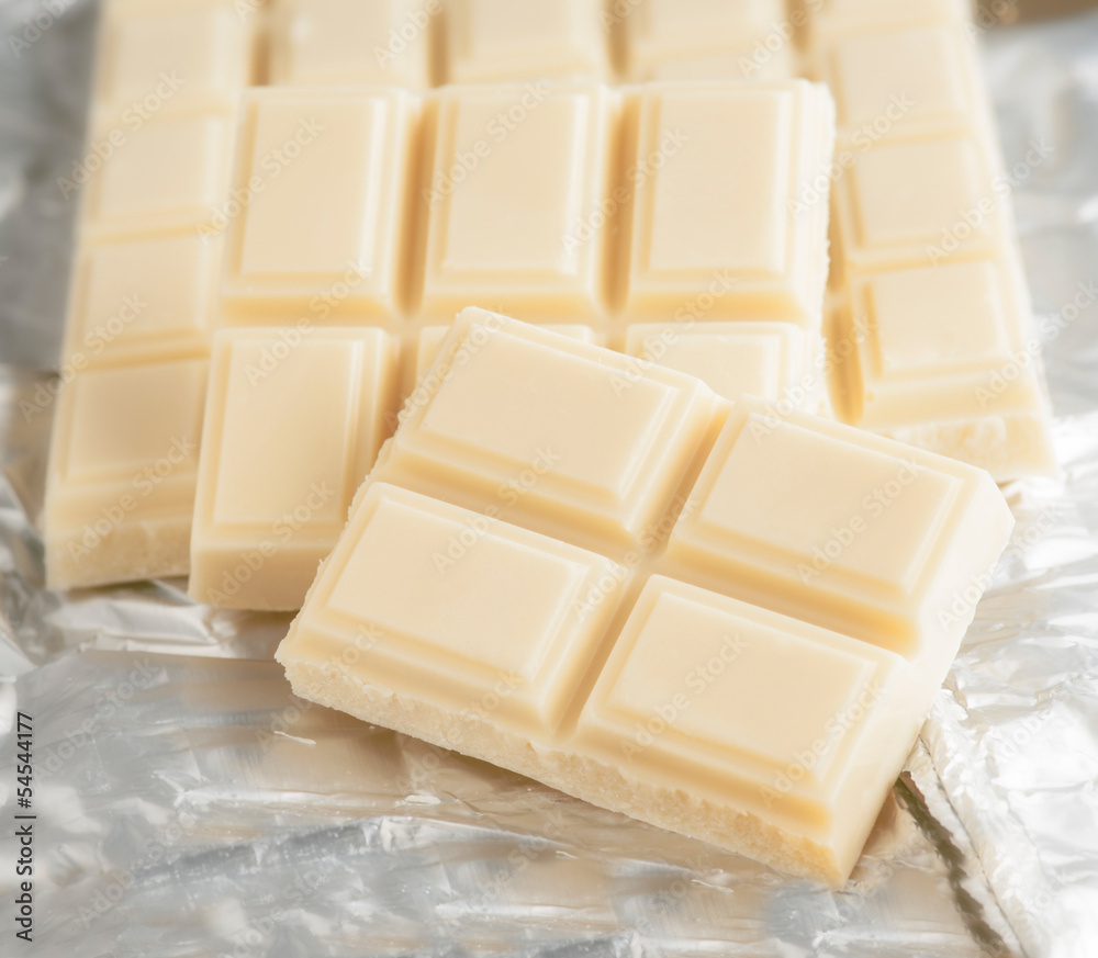 Tablet diced white chocolate on silver paper Tablet diced white chocolate on silver paper