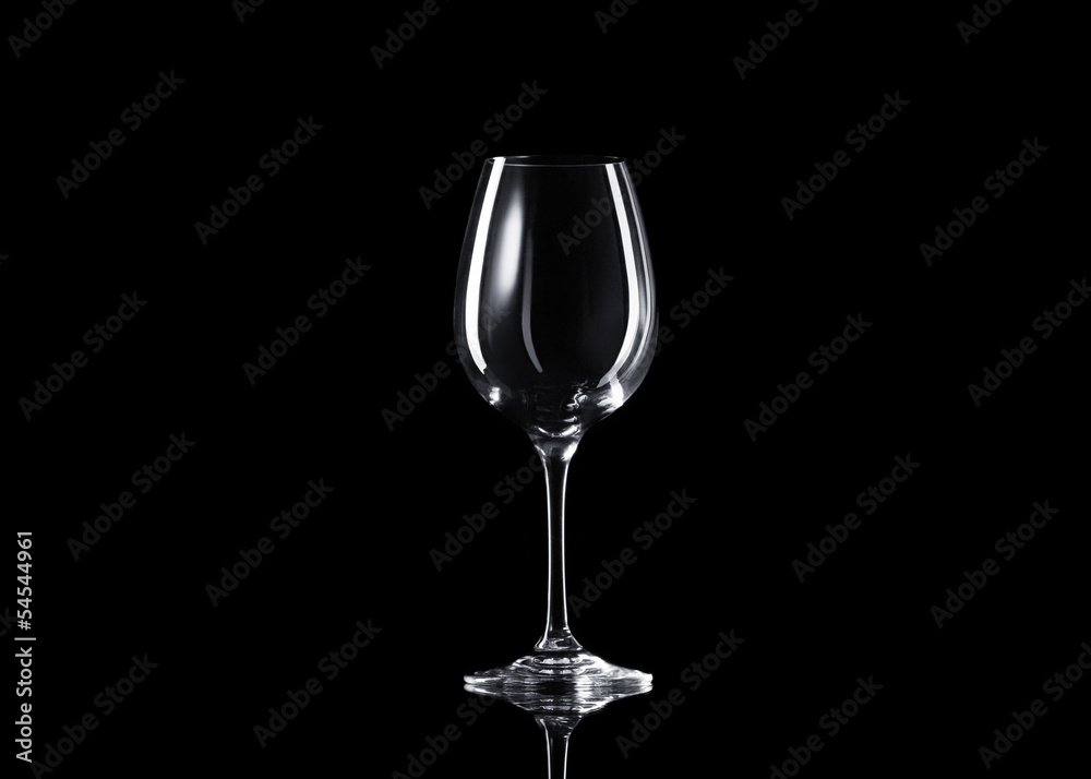 Empty glass of wine on black background