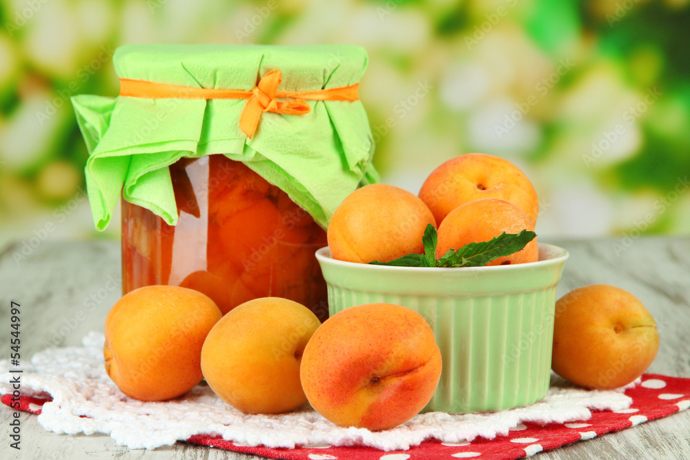 Apricot jam in glass jar and fresh apricots,