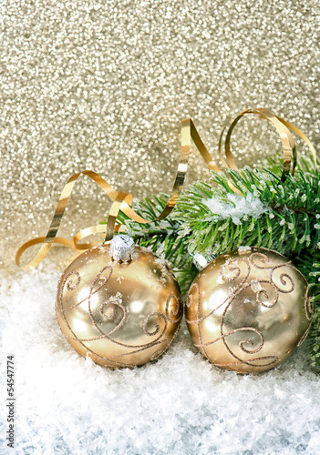 golden christmas ball with christmas tree branch photo