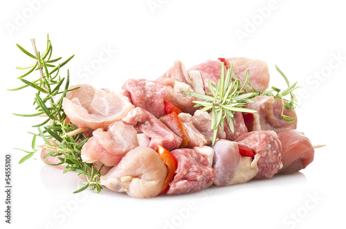chicken skewers and rosemary close up on white
