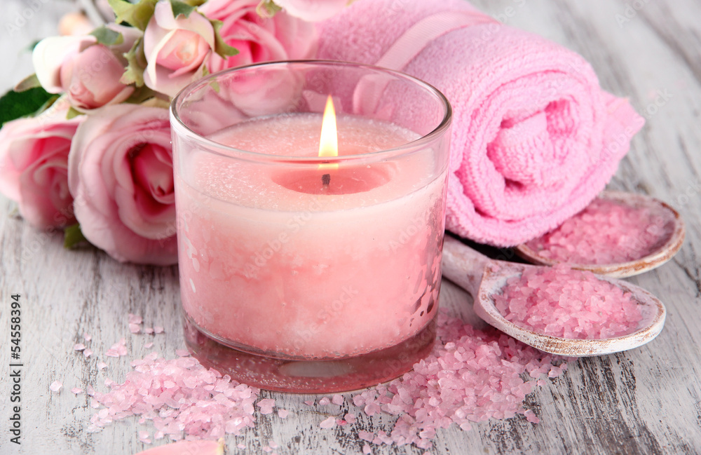 Beautiful spa setting with pink candle and flowers