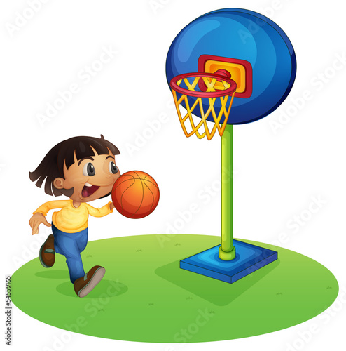 A small boy playing basketball
