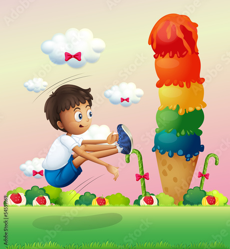 A boy exercising near the giant ice cream