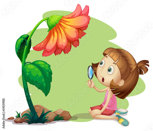 A girl holding a magnifying glass under a flower