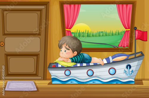 A sad little boy inside the house