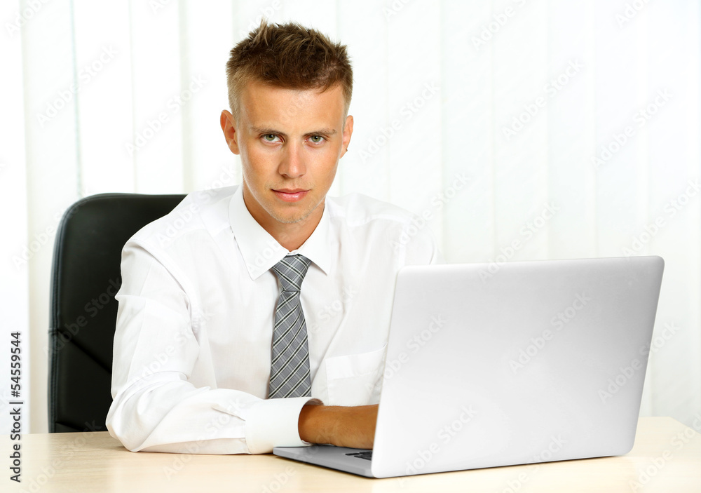 Portrait of young businessman working in office Portrait of young businessman working in office