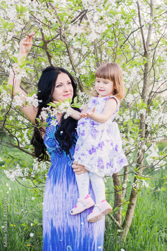 Happy mother with toddler in spring garden Happy mother with toddler in spring garden