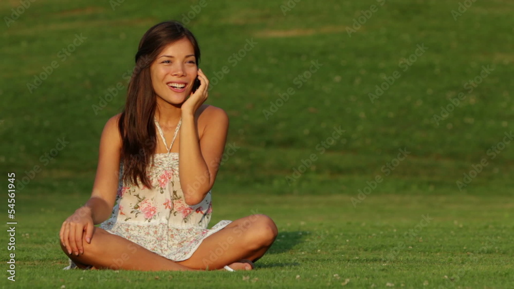 Girl talking on mobile phone outdoors laughing Girl talking on mobile phone outdoors laughing