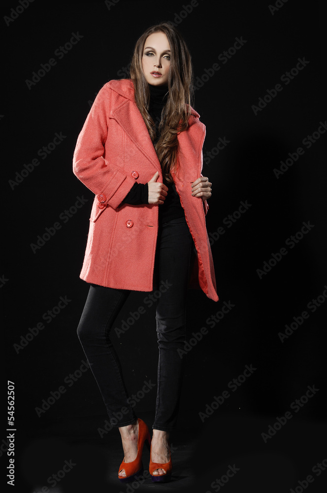 Full body A young pretty standing in a red winter coat Full body A young pretty standing in a red winter coat