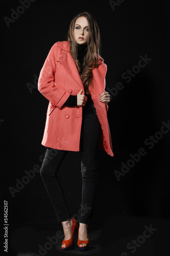 Full body A young pretty standing in a red winter coat