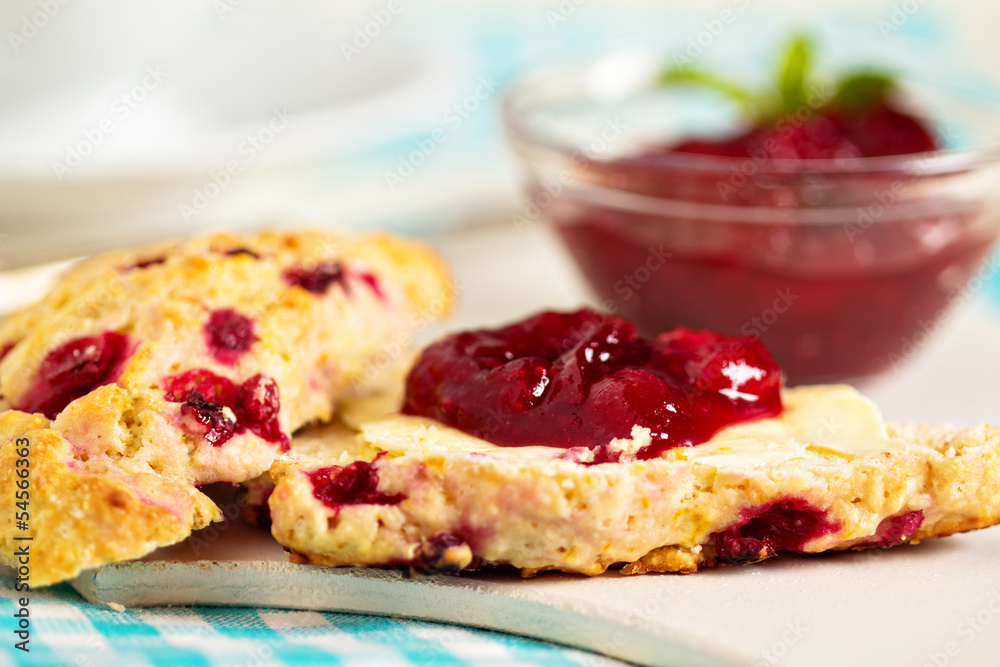 Scone with orange zest and berries with butter and jam Scone with orange zest and berries with butter and jam