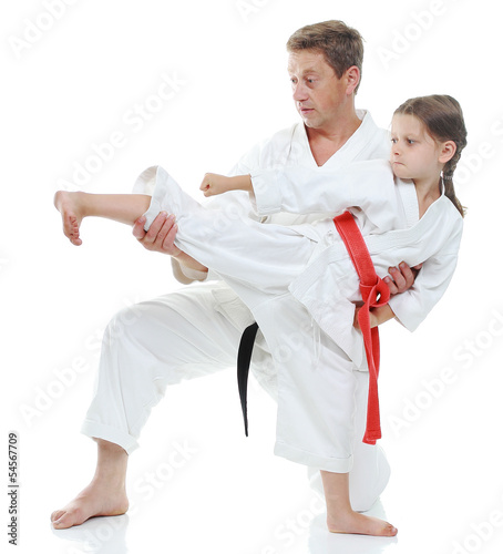 Girl learns to beat kick leg on white background