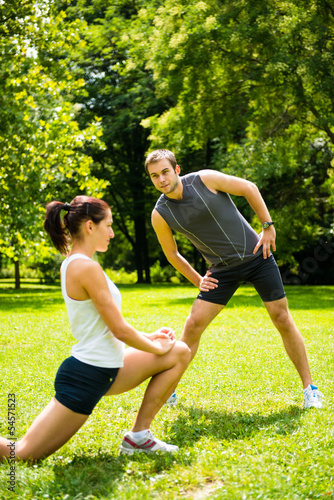 Fototapeta Naklejka Na Ścianę i Meble -  Warm up - couple exercising before jogging