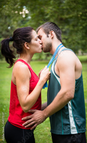 Young sport kissing couple