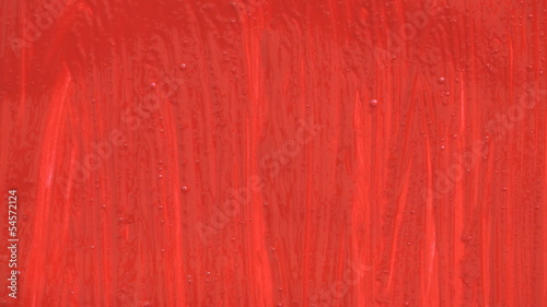 Hand with brush painting red background