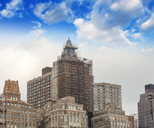 Group of old skyscrapers in New York against beautiful sky