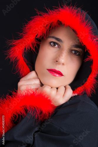 Portrait of sad woman in black cape and red fringe