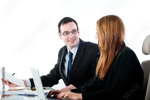 Two colleagues working together on a laptop computer