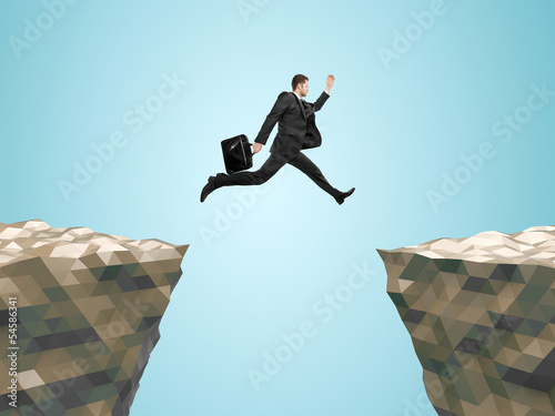 businessman with briefcase jumping