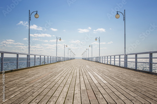 Fototapeta Naklejka Na Ścianę i Meble -  Old empty wooden pier over the sea shore with copy space