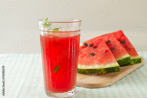 Glass of watermelon smoothie isolated on white.