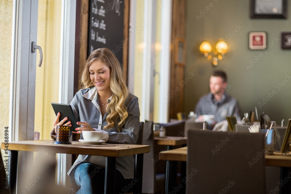 Pregnant Woman Using Digital Table In Cafe Pregnant Woman Using Digital Table In Cafe