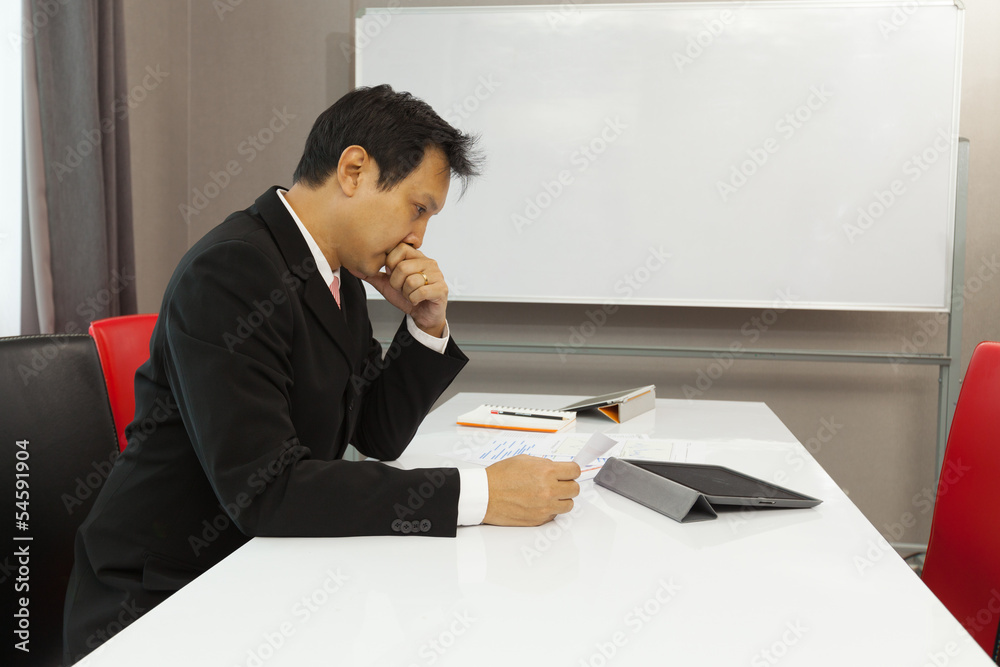 Businessman thinking about his business in a meeting room Businessman thinking about his business in a meeting room