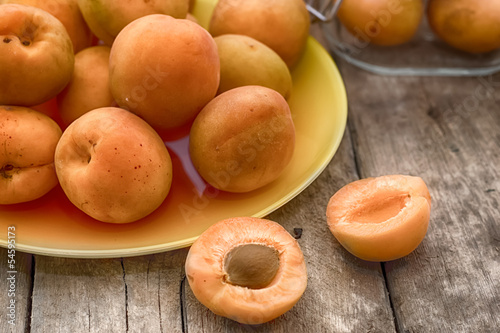 Ripe apricot on a wooden background