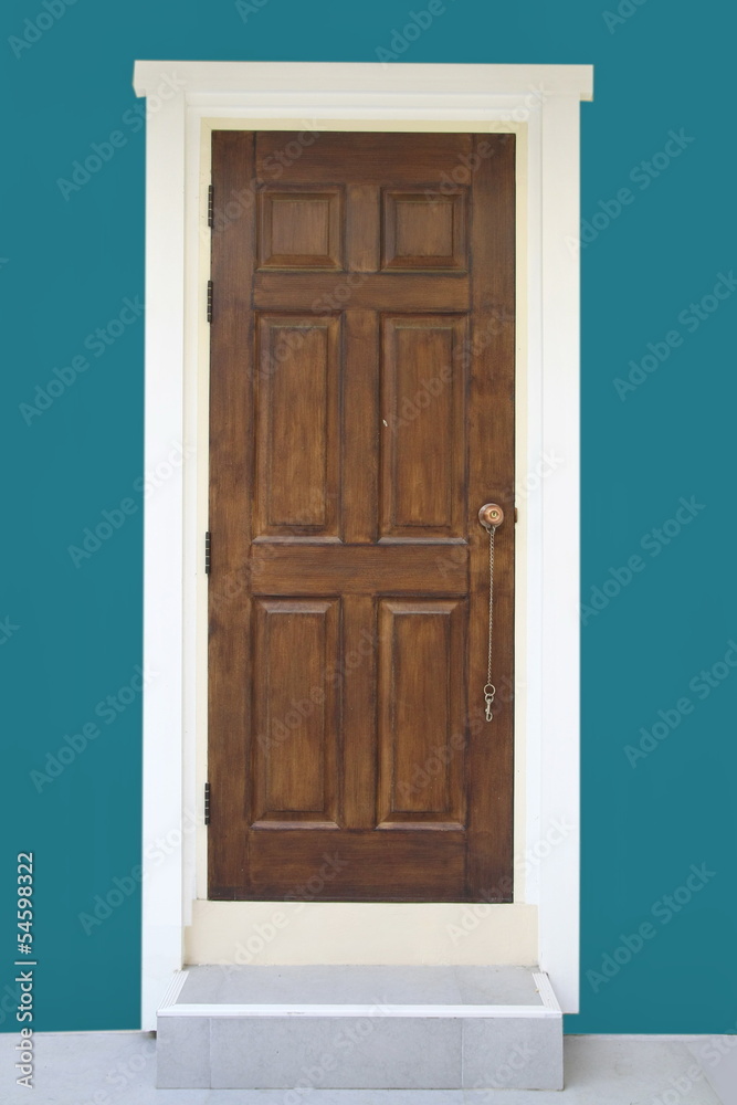 brown wood door with green wall
