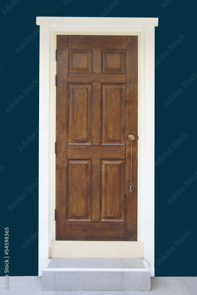 Brown wood door with dark green wall