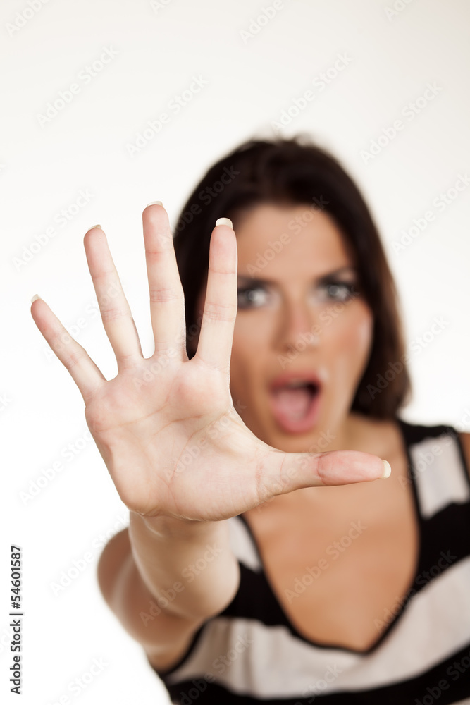 serious girl who shouts, showing stop sign with her hand serious girl who shouts, showing stop sign with her hand