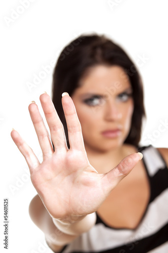 Serious girl showing stop sign with her hand