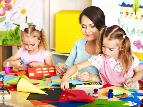 Children with teacher at classroom.