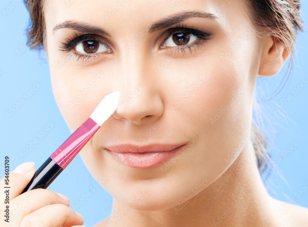 Woman with cosmetics brush, on blue Woman with cosmetics brush, on blue